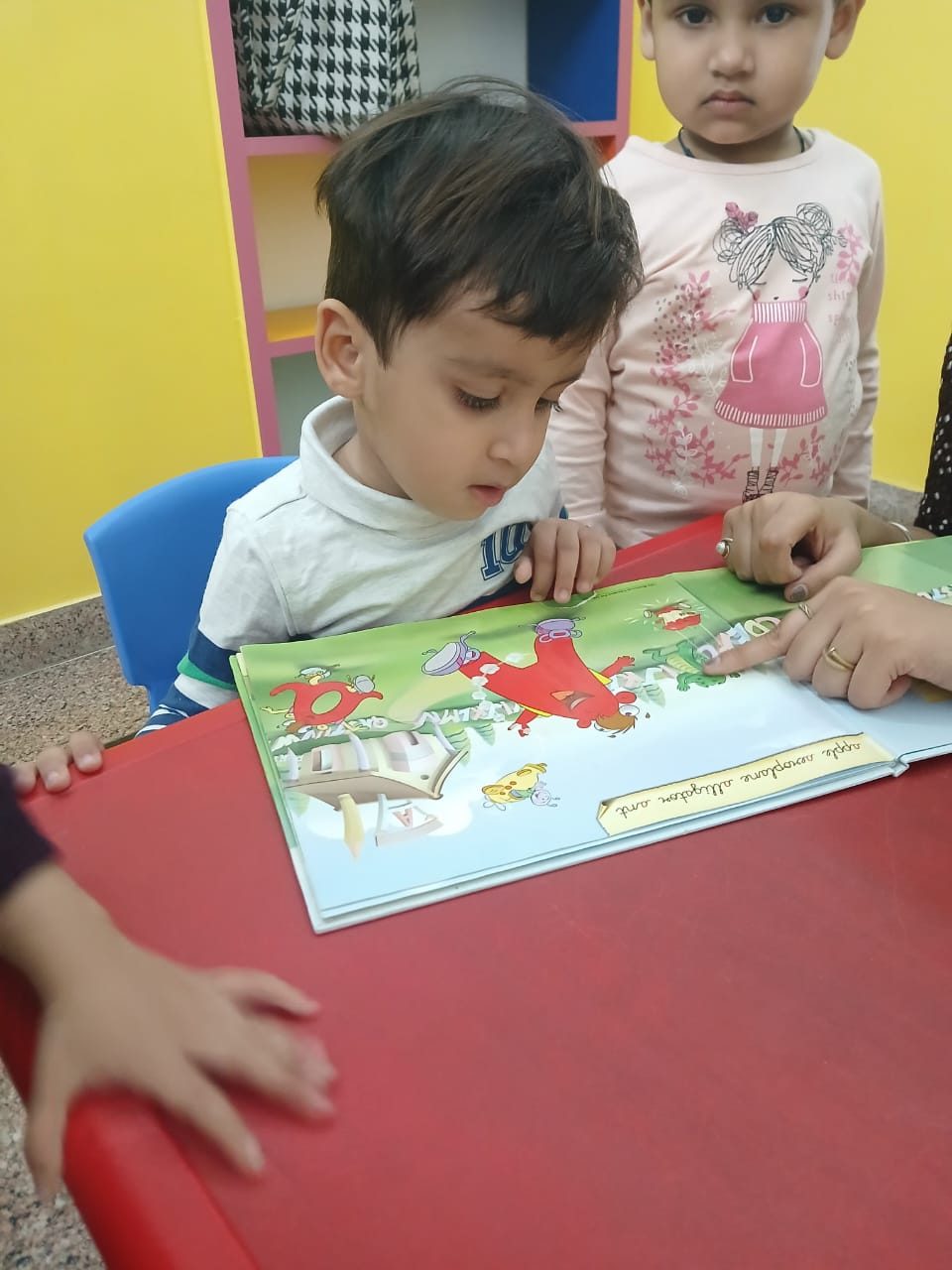 Music session with children playing tambourines and shakers at Edujoy